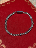Silver cuban magnetic bracelet by Oruma on a red background