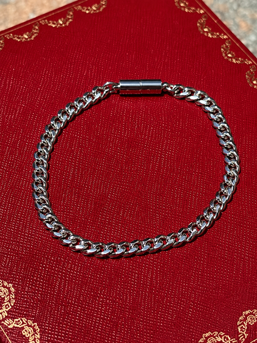 Silver cuban magnetic bracelet by Oruma on a red background